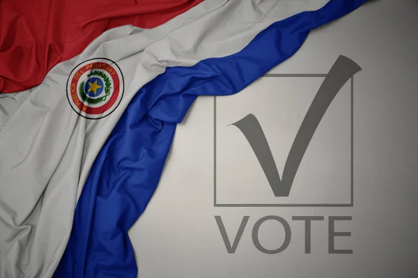 Махаючи Барвистим Національним Прапором Парагваю Сірому Фоні Текстовим Голосуванням Концепція — стокове фото
