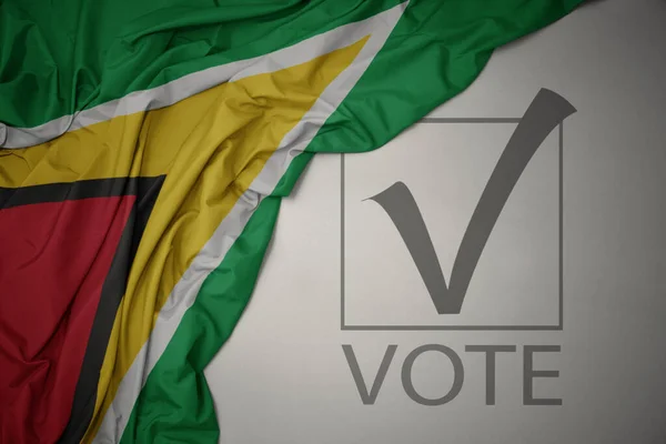 Viftar Färgglada Nationella Flagga Guyana Grå Bakgrund Med Text Rösta — Stockfoto