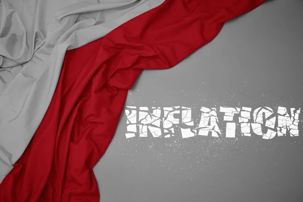 waving colorful national flag of poland on a gray background with broken text inflation. concept. 3d illustration