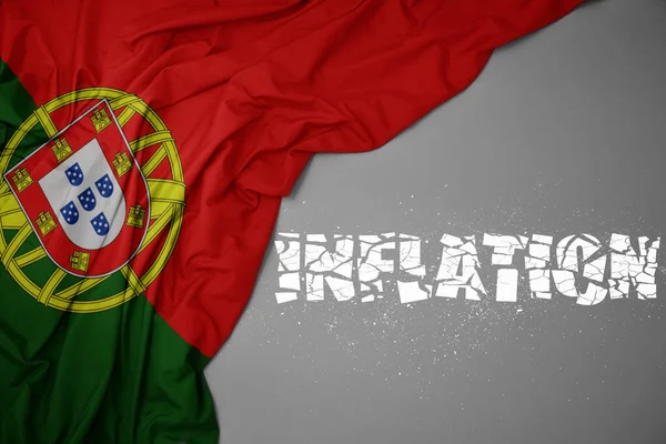 waving colorful national flag of portugal on a gray background with broken text inflation. concept. 3d illustration