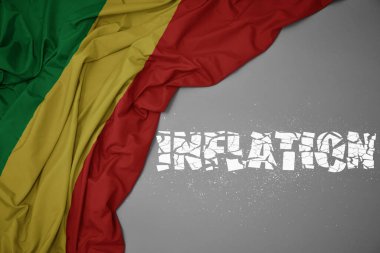 waving colorful national flag of republic of the congo on a gray background with broken text inflation. concept. 3d illustration clipart
