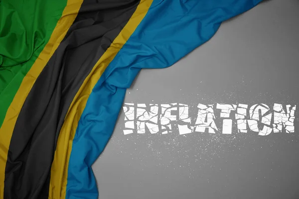 灰色の背景にタンザニアのカラフルな国旗を振っています コンセプト 3Dイラスト — ストック写真