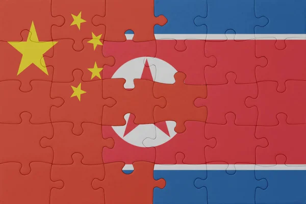 puzzle with the national flag of north korea and china . macro.concept. 3d illustration