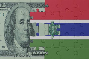 Ulusal Gambiya bayrağı ve dolar banknotuyla ilgili bulmacalar. Makro. Kavram. 3d illüstrasyon