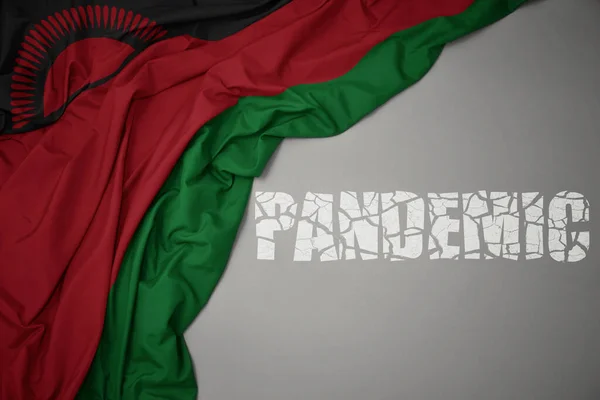 Размахивая Красочным Национальным Флагом Малави Сером Фоне Сломанной Текстовой Пандемией — стоковое фото
