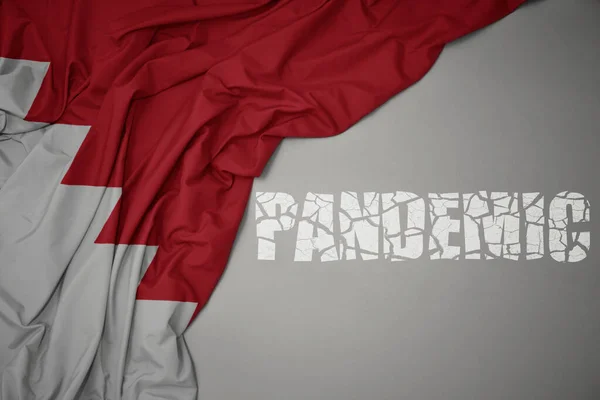 waving colorful national flag of bahrain on a gray background with broken text pandemic. concept. 3d illustration