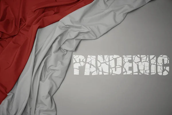 Mává Barevnou Národní Vlajkou Indonésie Šedém Pozadí Pandemií Zlomeného Textu — Stock fotografie