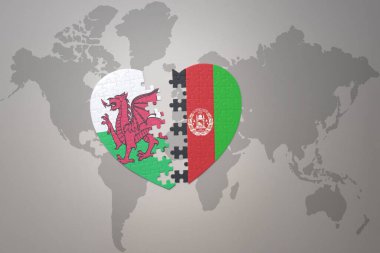 Afganistan ve Galler 'in ulusal bayrağıyla ilgili bir bulmaca kalbi dünya haritasında. 3B illüstrasyon