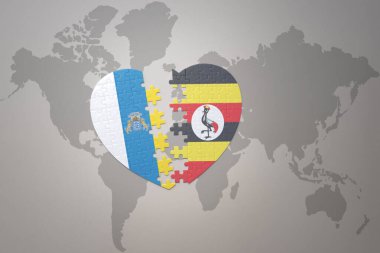 Uganda ve kanarya adalarının ulusal bayrağıyla bir dünya haritasında bulmaca kalbi. Konsept. 3B illüstrasyon