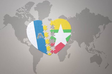 Myanmar Ulusal Bayrağı ve Kanarya Adaları 'nın yapboz kalbi dünya haritasının arka planında. 3B illüstrasyon
