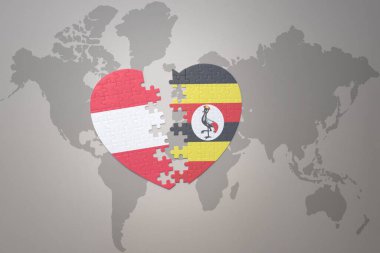 Uganda ve Avusturya 'nın ulusal bayrağıyla ilgili bir bulmaca kalbi dünya haritasında. 3B illüstrasyon