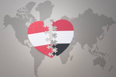 Dünya haritasında Yemen ve Avusturya 'nın ulusal bayrağıyla ilgili bir bulmaca kalbi. 3B illüstrasyon