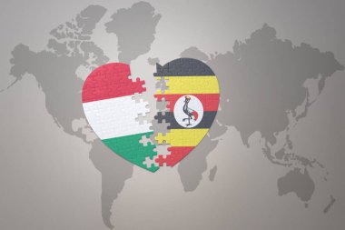 Dünya haritasında Uganda ve Hungary 'nin ulusal bayrağıyla bulmaca kalbi. 3B illüstrasyon