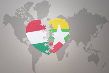 Myanmar ve Hungary 'nin ulusal bayrağıyla bir dünya haritasında bulmaca kalbi. 3B illüstrasyon