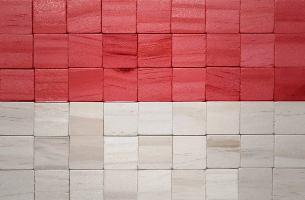 在木制立方体纹理上彩绘了色彩艳丽的印度尼西亚国旗 3D说明 — 图库照片