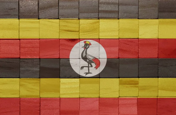 ウガンダの国旗を木のキューブ状にカラフルな絵で描いたものです 3Dイラスト — ストック写真