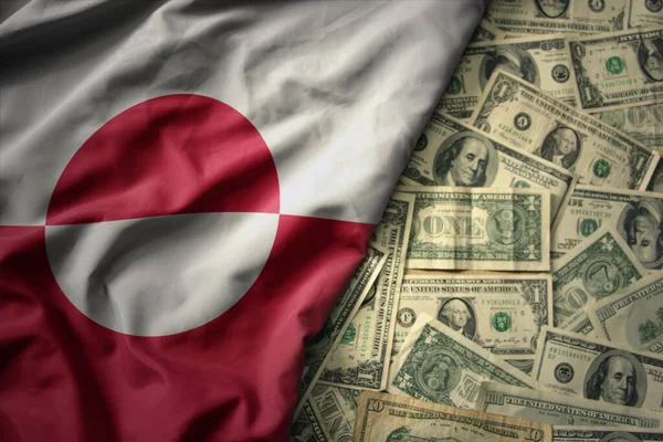 グリーンランドの国旗を米ドルの金の背景に振っているのです 金融の概念 — ストック写真