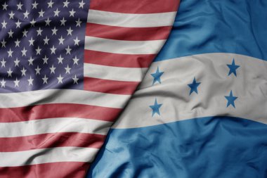 big waving colorful flag of united states of america and national flag of honduras . macro