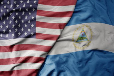 big waving colorful flag of united states of america and national flag of nicaragua . macro