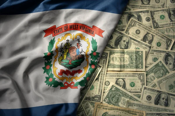 stock image big colorful waving national flag of west virginia state on a american dollar money background. finance concept