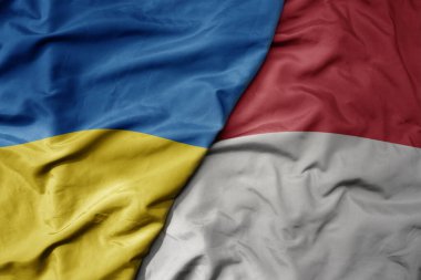 Ukrayna 'nın ulusal bayrağı ve Endonezya' nın ulusal bayrağı sallanıyor. makro