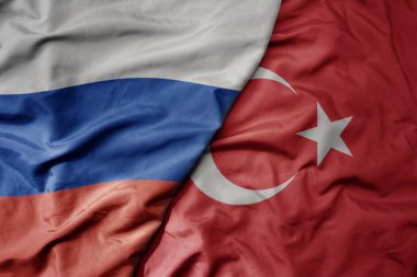 Büyük, gerçekçi, ulusal, renkli bir Rus bayrağı ve ulusal bir hindi bayrağı sallıyor. makro