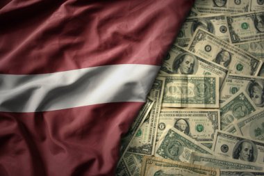 Amerikan dolarları üzerinde Letonya 'nın ulusal bayrağını sallayan büyük renkli bir bayrak. finans kavramı