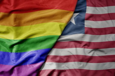 Liberya 'nın ulusal renkli bayrağı ve gökkuşağı eşcinsellik gururu bayrağı sallanıyor. makro