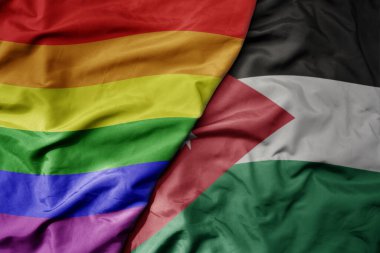 Ürdün 'ün ulusal renkli bayrağı ve gökkuşağı gay gurur bayrağı sallanıyor. makro