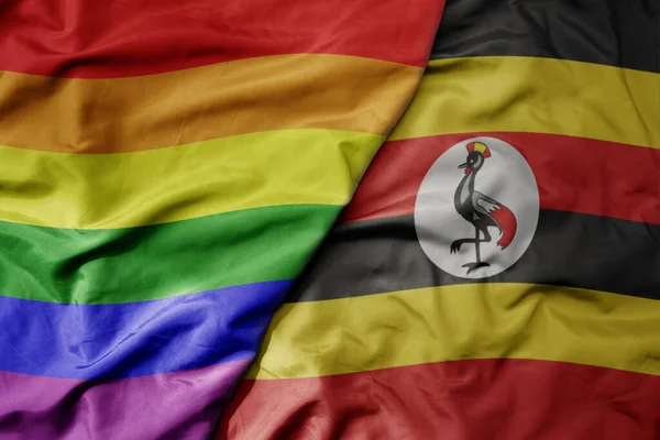 Stora Viftande Realistiska Nationella Färgglada Flagga Uganda Och Regnbåge Gay — Stockfoto