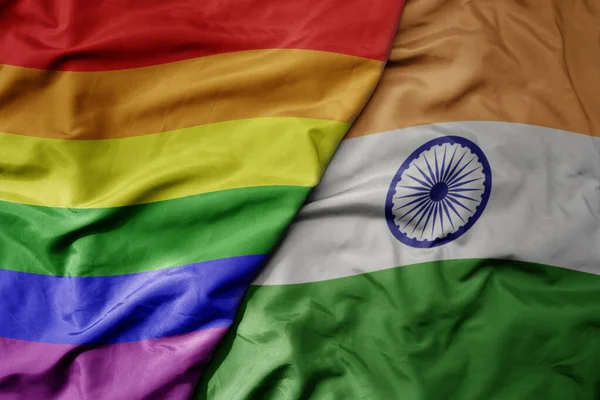 big waving realistic national colorful flag of india and rainbow gay pride flag . macro
