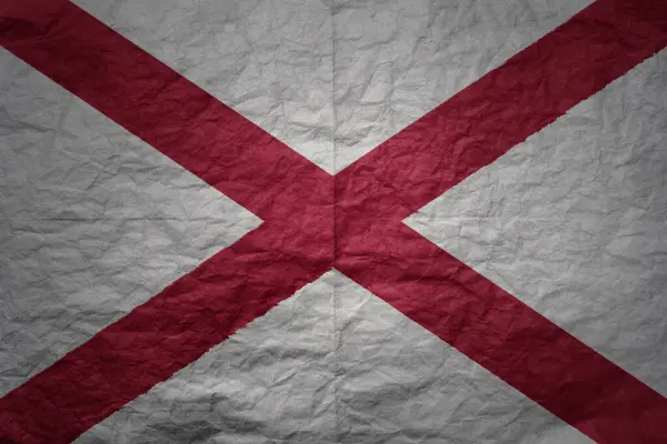 stock image colorful big national flag of alabama state on a grunge old paper texture background