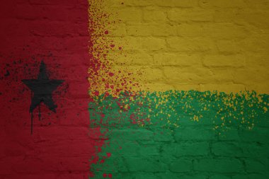 colorful painted big national flag of guinea bissau on a massive old brick wall clipart