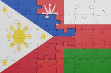 Umman 'ın renkli ulusal bayrağı ve Filipinler bayrağı ile bulmaca. konsept