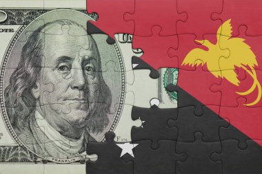 Papua Yeni Gine 'nin renkli ulusal bayrağı ve ABD Doları Para .finans kavramının bulmacası