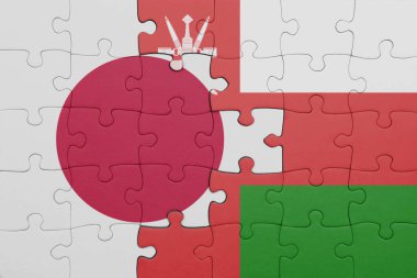 Umman 'ın renkli ulusal bayrağı ve Japon bayrağı ile bulmaca. konsept