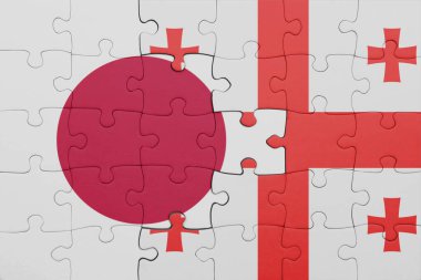 Gürcistan 'ın renkli ulusal bayrağı ve Japonya bayrağı ile bulmaca. konsept