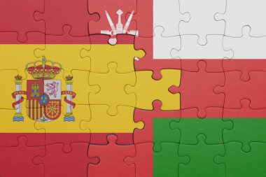 Umman 'ın renkli ulusal bayrağı ve İspanya bayrağı ile bulmaca. konsept