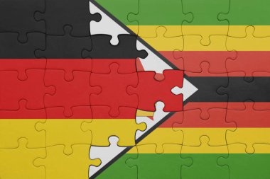 Zimbabwe 'nin renkli ulusal bayrağı ve Almanya bayrağı ile bulmaca. konsept