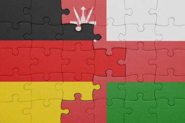 Umman 'ın renkli ulusal bayrağı ve Alman bayrağıyla bulmaca. konsept