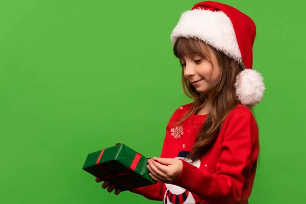 Cute Little Girl Santa Hat Unpacks New Years Gift Merry — Stock Photo, Image