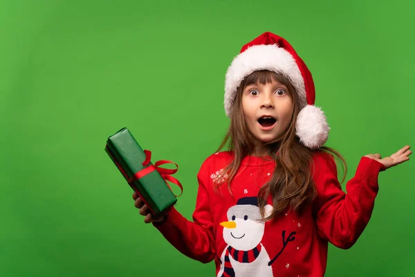 Portrait Emotional Surprised Girl Red Knitted Sweater Santa Hat Holds — Stock Photo, Image