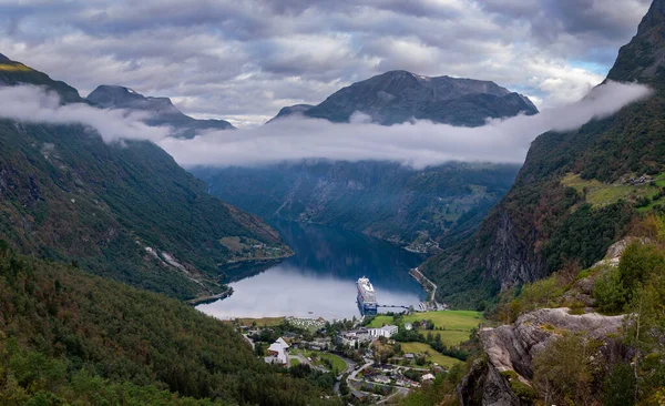 stock image Breathtaking nature: mountains, fog, fjord, ferry, clouds. Tranquil and captivating travel destination.