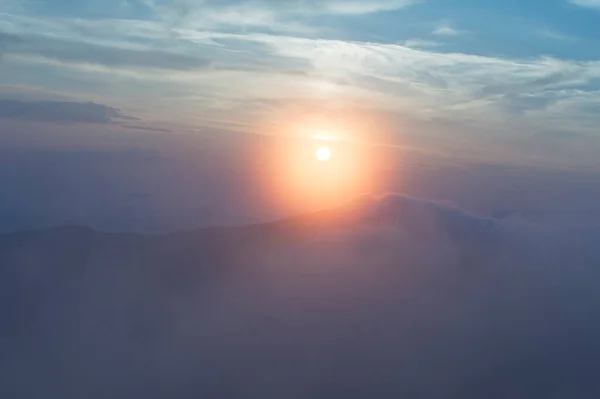 stock image sunset in the mountains, mountains in the clouds in a haze