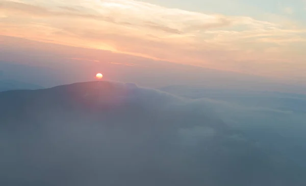 stock image sunset in the mountains, mountains in the clouds in a haze