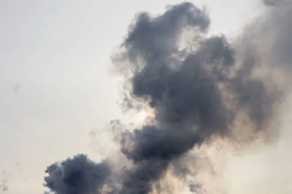 stock image black thick smoke against the sky