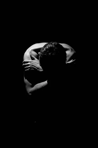 expressive photo, man on a black background in a closed pose