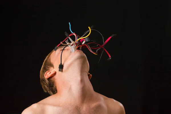 man on a black background wires from mouth concept technologies captivated of man