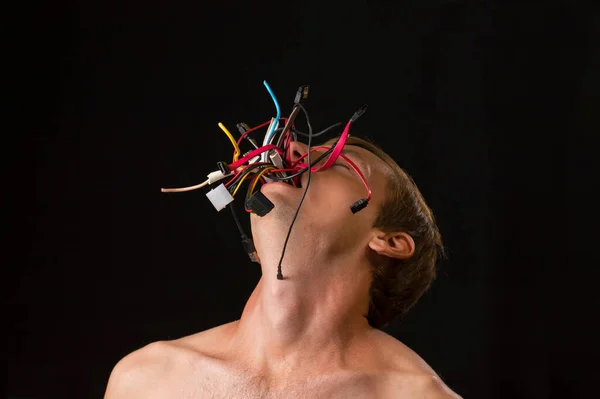man on a black background wires from mouth concept technologies captivated of man