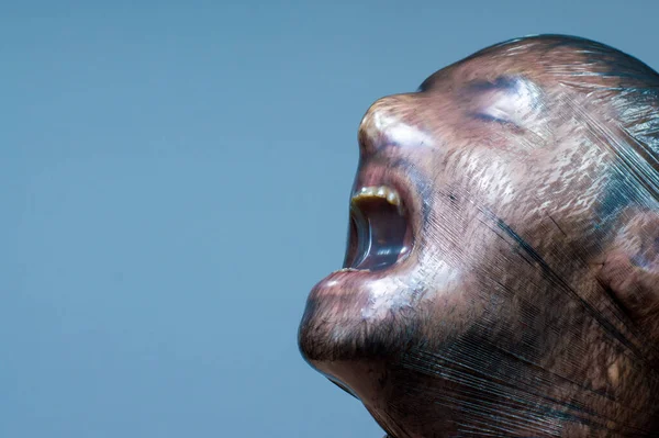 stock image A man with a plastic bag over his head is suffocating